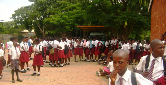 Form 1 and 2 students waiting for the assembly to begin before going for classes